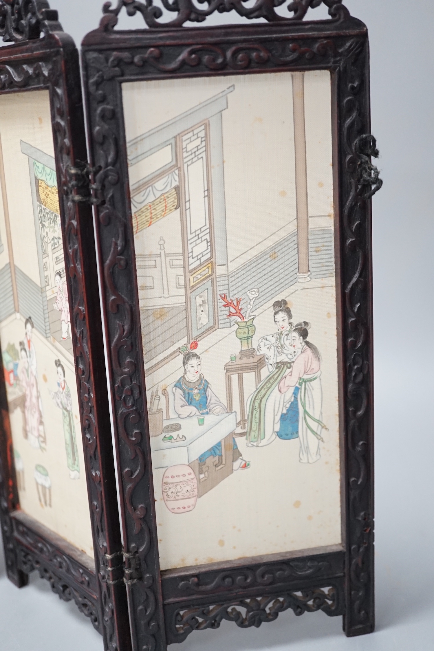 A Chinese hardwood framed painted silk four fold miniature screen, inset with painted silk panels, 28cm